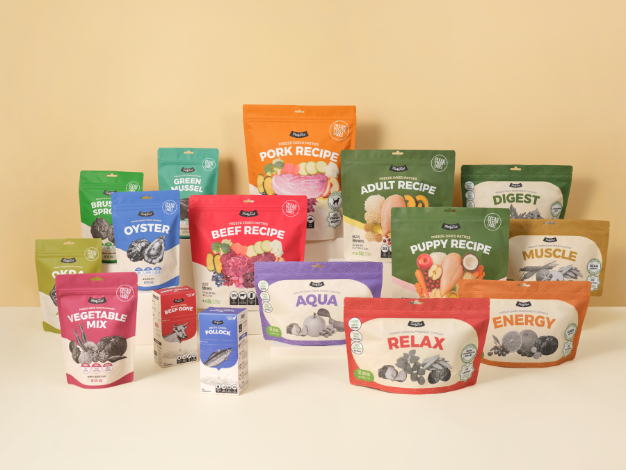 Two TrustyFood freeze-dried food pouches styled with raw ingredients